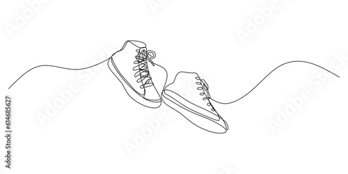 Continuous single one line of sneakers shoes isolated on white background.