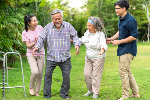 Portrait enjoy happy smiling love multi-generation asian big hug family.Senior mature father and elderly mother with young adult woman and son outdoor in park at home.insurance concept © Art_Photo