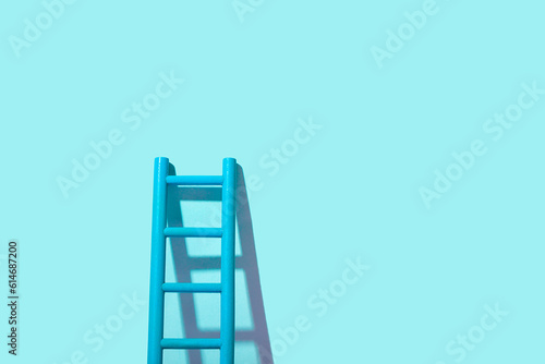 Development concept. Ladder up on blue background with copy space.