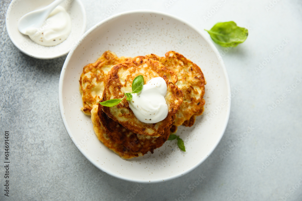 Traditional homemade latkes with sour cream