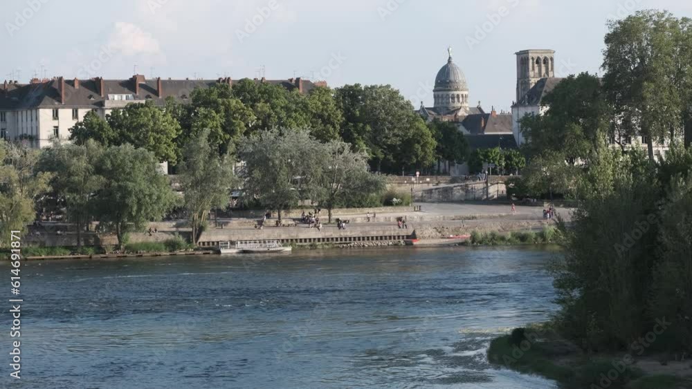 Wide panorama over river Loire with dome of Basilica Saint Martin in view and river promenade Wide panorama over river Loire with dome of Basilica Saint Martin in view and river promenade