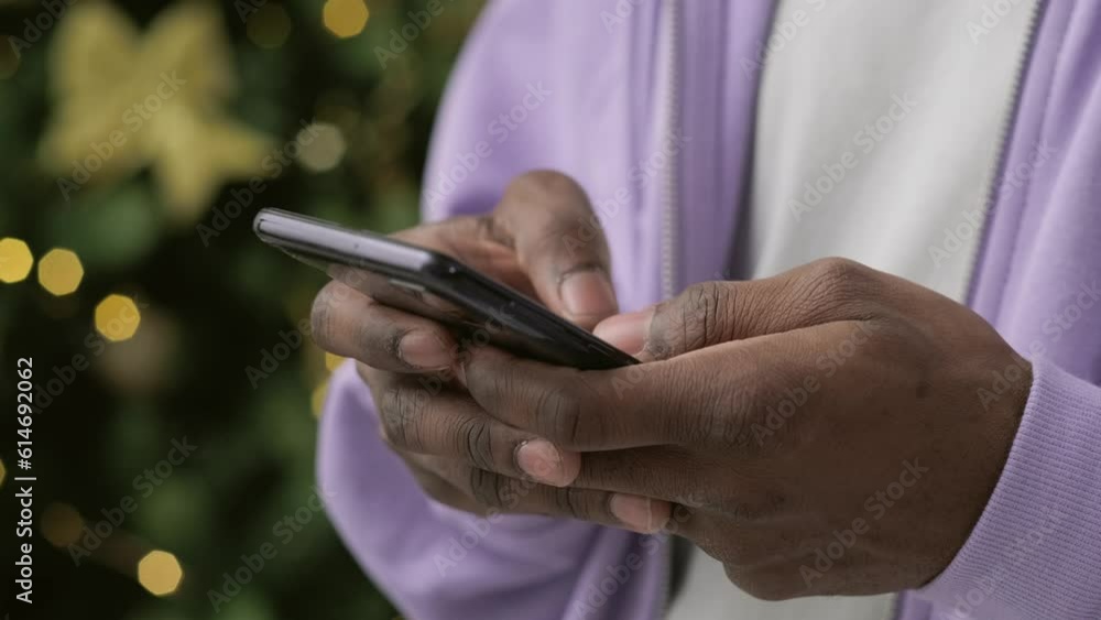 Christmas sales, online shopping, close up black hands man using smartphone pressing finger, reading social media internet, typing text or shopping online, Mobile phone in two hands Christmas sales, online shopping, close up black hands man using smartphone pressing finger, reading social media internet, typing text or shopping online, Mobile phone in two hands