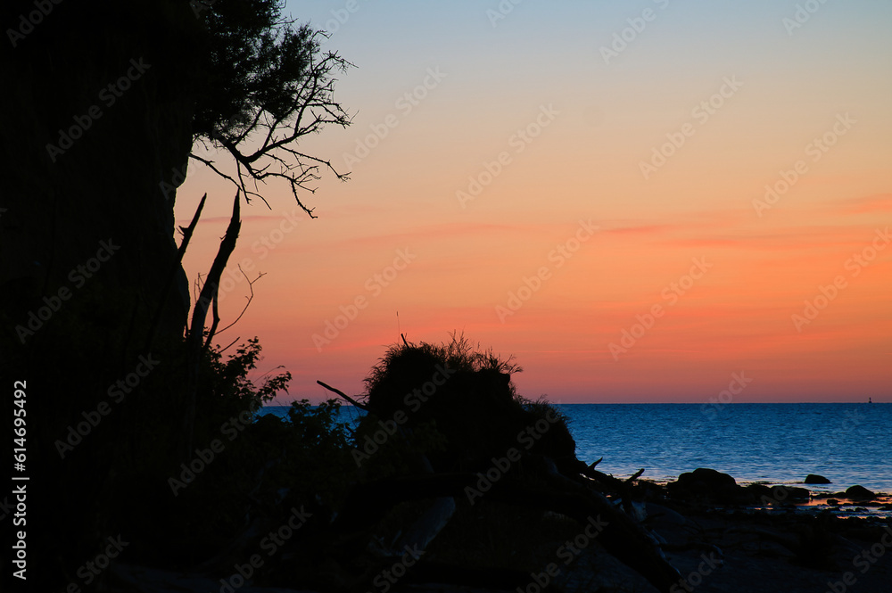 Steep coast on the island of Poel at sunset with a view of the pastel sky