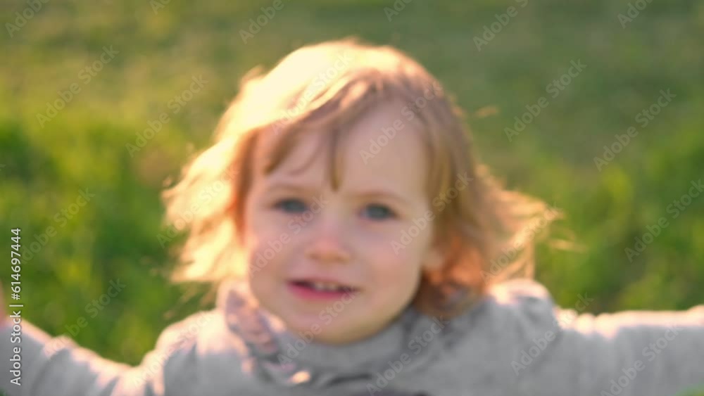 Girl on a swing. Little 2 years child swinging in summer at sunset. Slow motion of beautiful baby sitting on a swing in a park, sunny evening. Smiling young kid enjoying the rope seesaw at playground. Girl on a swing. Little 2 years child swinging in summer at sunset. Slow motion of beautiful baby sitting on a swing in a park, sunny evening. Smiling young kid enjoying the rope seesaw at playground.