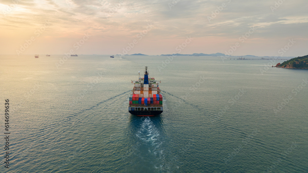 Aerial Stern of cargo container ship with contrail in the ocean ship carrying container and running for export concept technology freight shipping by ship at sunset Aerial Stern of cargo container ship with contrail in the ocean ship carrying container and running for export concept technology freight shipping by ship at sunset