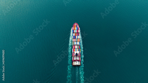 Aerial Stern of cargo container ship with contrail in the ocean ship carrying container and running for export concept technology freight shipping by ship at sunset © Yellow Boat