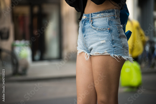 Closeup of mini jeans short on woman in the street photo