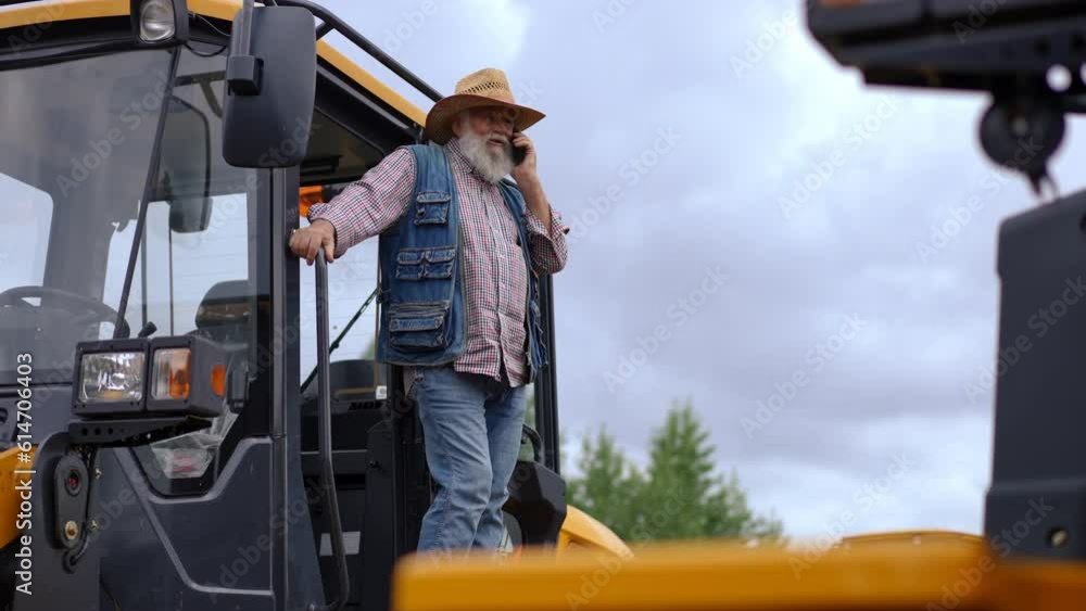 custom made wallpaper toronto digitalWide shot bearded senior farmer in straw hat talking on phone in slow motion standing at tractor. Portrait of confident Caucasian expert man at harvester outdoors