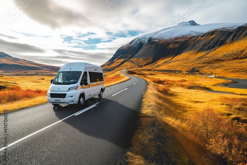 Embarking on a family vacation adventure, a campervan drives along a breathtaking mountain road with snow-capped peaks.