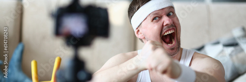 Canvas Print Cheerful funny trainer blogger emotionally screaming at camera
