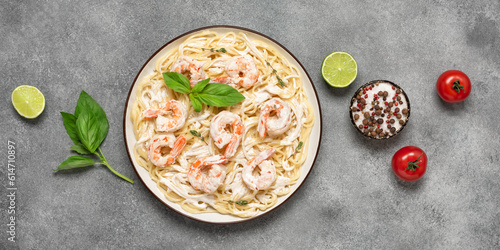 Spaghetti pasta with shrimps scampi on a gray concrete background. Top view, flat lay, copy space. Banner