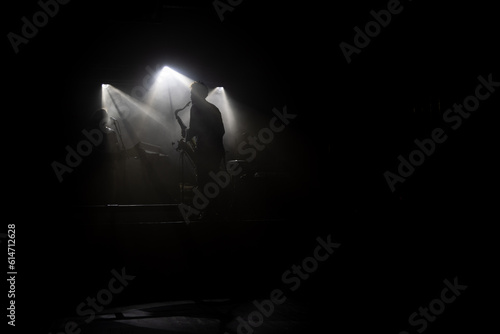 spotlights on stage and a silhouette of a saxsophone 