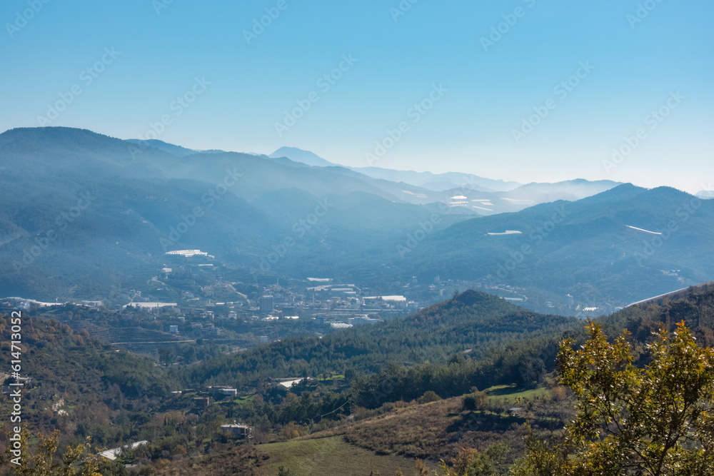 A Mediterranean valley on a sunny day with the mountains in the background