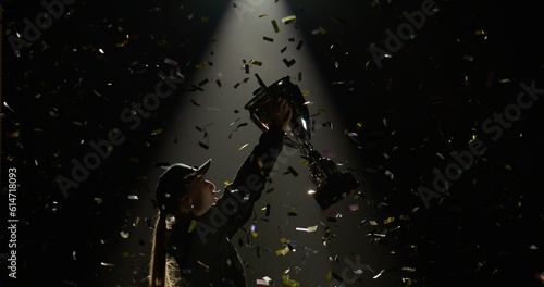Fényképezés Silhouette of female woman race car driver celebrating the win in a race against