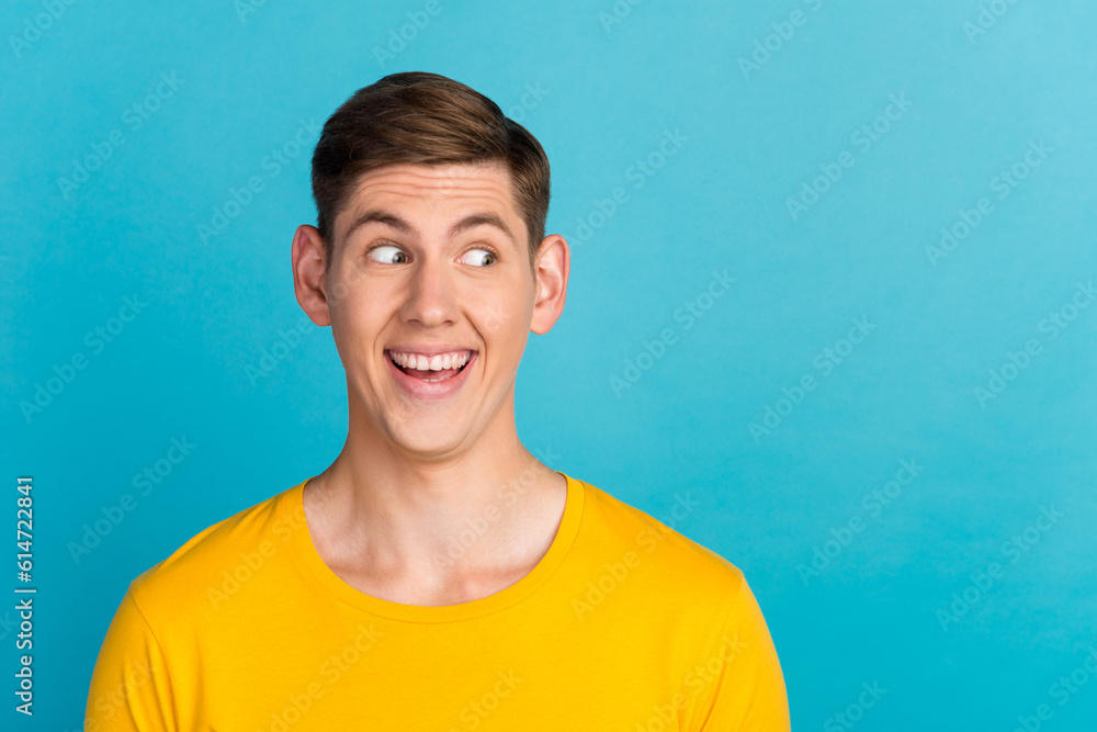 Portrait of funny young guy looking side interesting idea wear stylish clothes isolated over yellow color background Portrait of funny young guy looking side interesting idea wear stylish clothes isolated over yellow color background