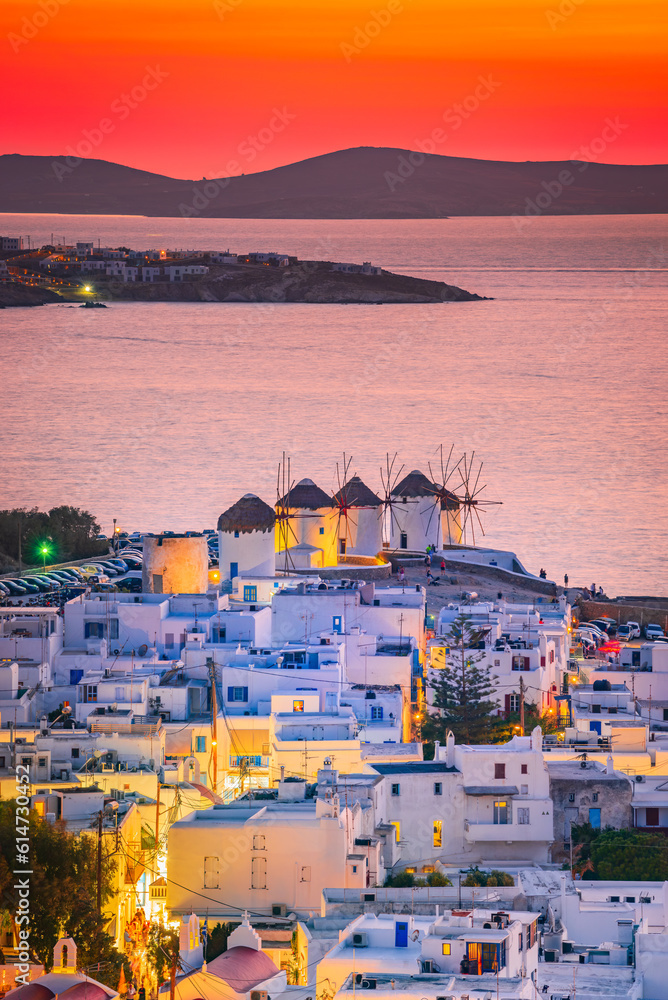 Mykonos, Greece. Sunset over Aegean Sea and the famous windmill from above, Cyclades.