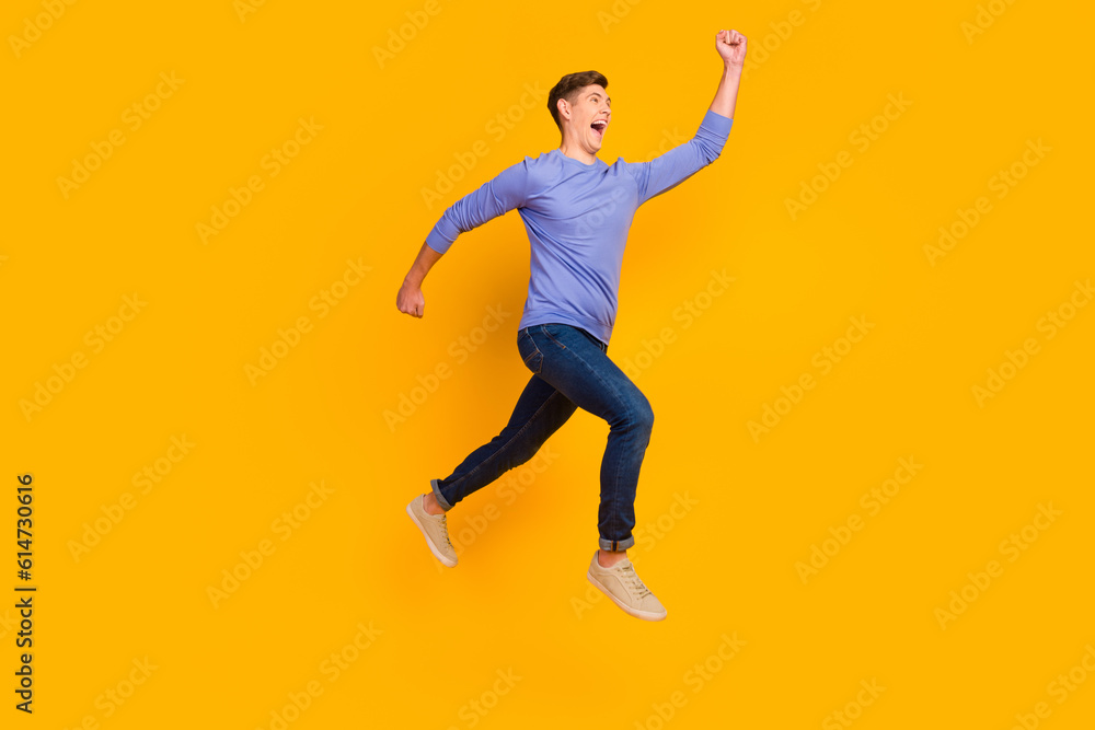 Full length side profile body size photo of jumping run fast man rushing wearing casual jeans shirt isolated on yellow background