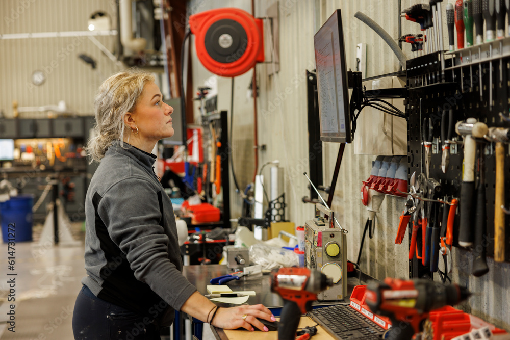 © Johnér - Young female industrial worker working in factory