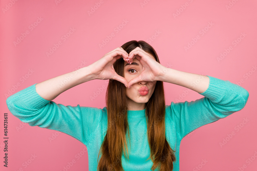 Portrait of attractive lovely cheery girl showing heart sign on eye isolated on pastel color background Portrait of attractive lovely cheery girl showing heart sign on eye isolated on pastel color background