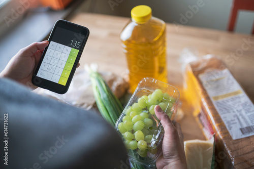 Person checking prices after shopping