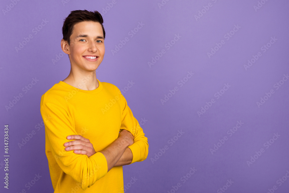 Turned photo of young intelligent man stand empty space cross arms wear yellow shirt isolated bright color background Turned photo of young intelligent man stand empty space cross arms wear yellow shirt isolated bright color background