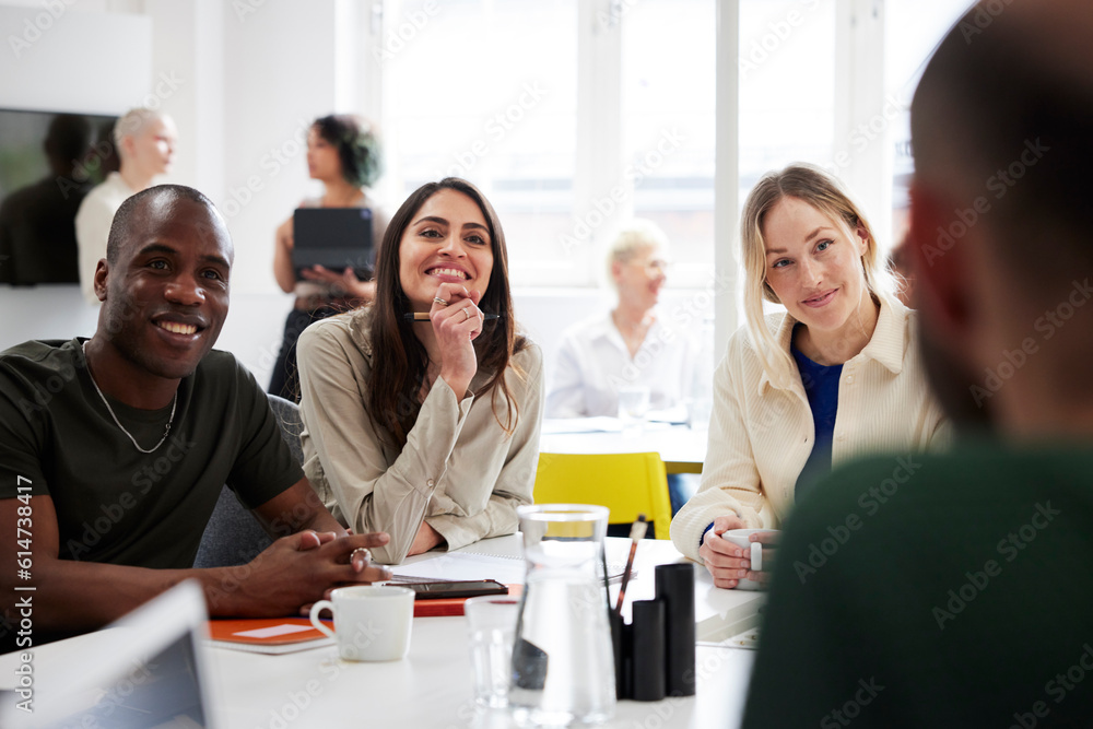 Group of business people discussing project in office Group of business people discussing project in office
