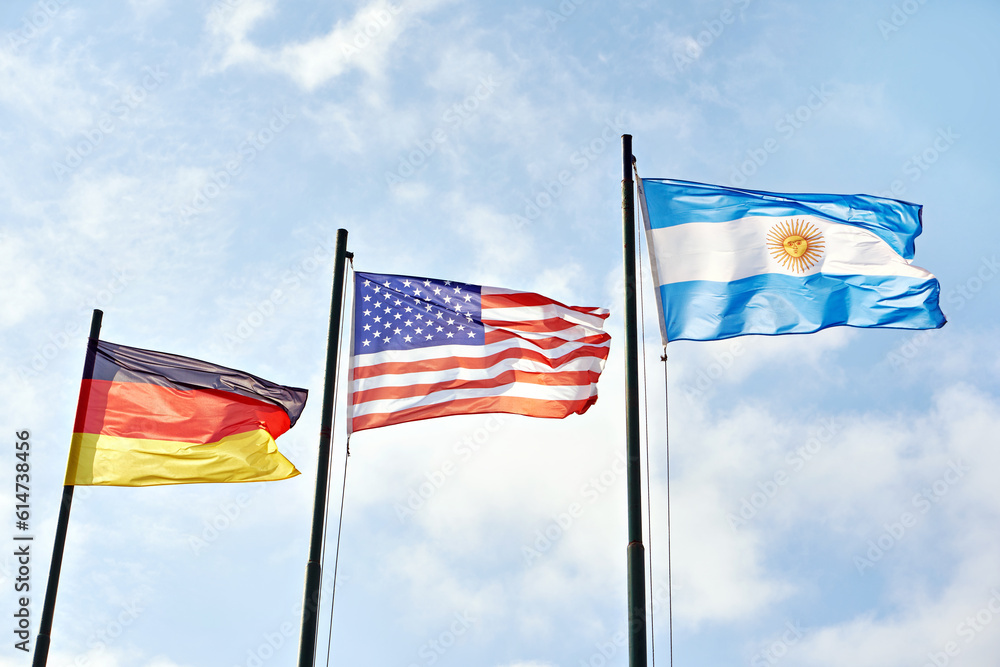 Germany, USA and Argentina flags on sky