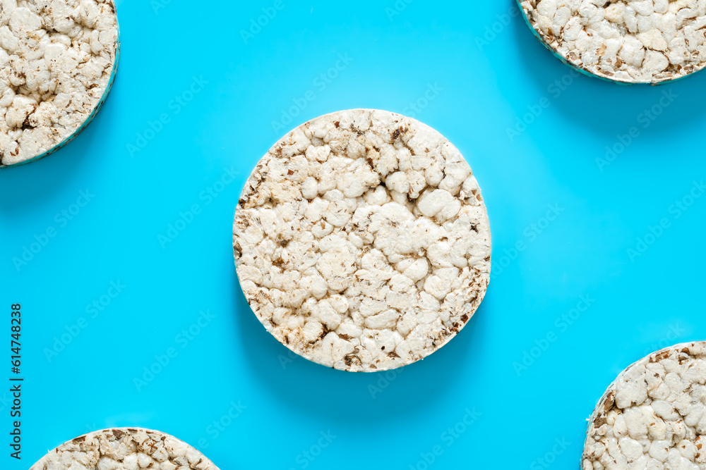 Puffed rice cakes on blue background, flat lay. Puffed rice cakes on blue background, flat lay.