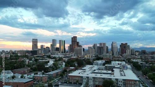 Aerial hyperlapse of the Denver, Colorado skyline at dusk with dramatic clouds. Drone view of downtown Denver from RiNo district.