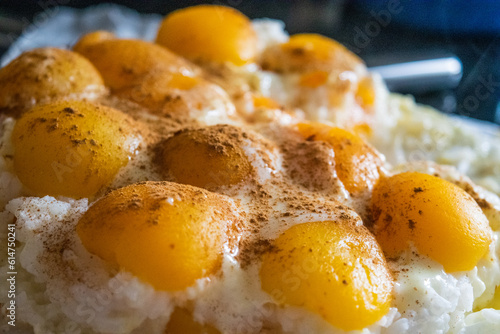 rice with pudding and peaches and cinnamon