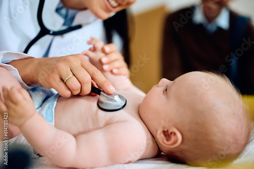 Valokuva Close up of doctor examining baby with stethoscope at clinic.