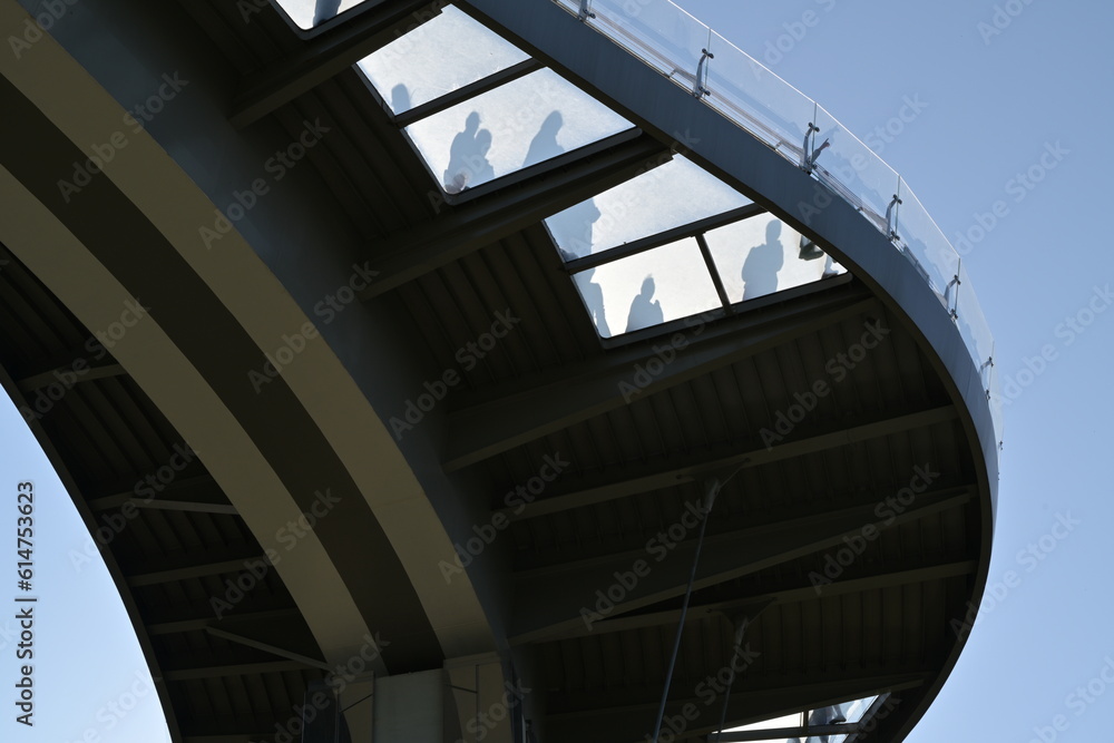 shadows of people in the glass window of the bridge shadows of people in the glass window of the bridge