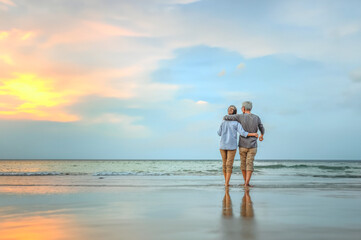 Seniors go on vacation at the beach. Seniors plan for retirement with insurance. Seniors are retired. Plan life insurance of happy retirement concepts. Senior couple walking.