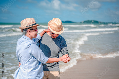 Plan life insurance of happy retirement concepts. Focus on Senior couple dancing at the beach looking the ocean on a good day in sunny day morning.