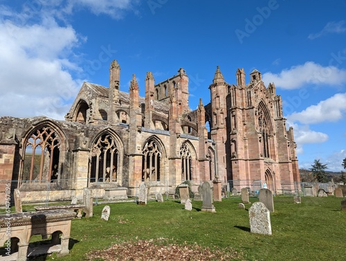 The beautiful ruined Abbey of St. Mary found in Melrose a town in the Scottish borders in the UK.  photo