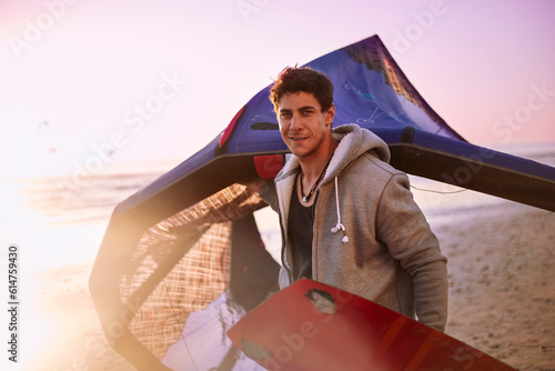 Wall Mural Portrait confident man carrying kiteboard equipment on beach