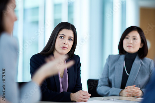Attentive businesswoman listening to colleague in meeting