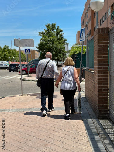 Couple walking in the street. Sunny day, people, walk, background, park, together, old © Юля Федоренко