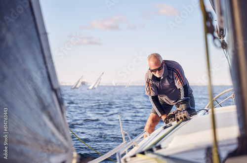 Retired man sailing sailboat