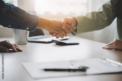  hands of agent and client shaking hands after signed contract buy new apartment.