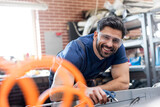 Portrait smiling mechanic working in auto repair shop