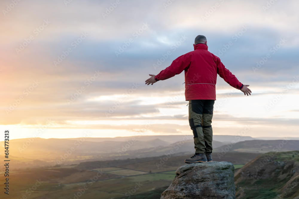 Bearded Man in orange jacket relaxing alone on the top of mountain and drinking hot coffee at sunrise. Travel Lifestyle concept The national park Peak District in England Bearded Man in orange jacket relaxing alone on the top of mountain and drinking hot coffee at sunrise. Travel Lifestyle concept The national park Peak District in England
