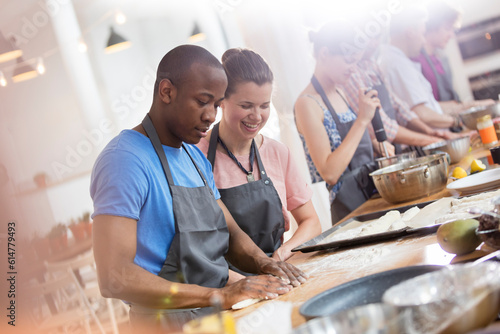 Fotografie Couple enjoying cooking class in kitchen