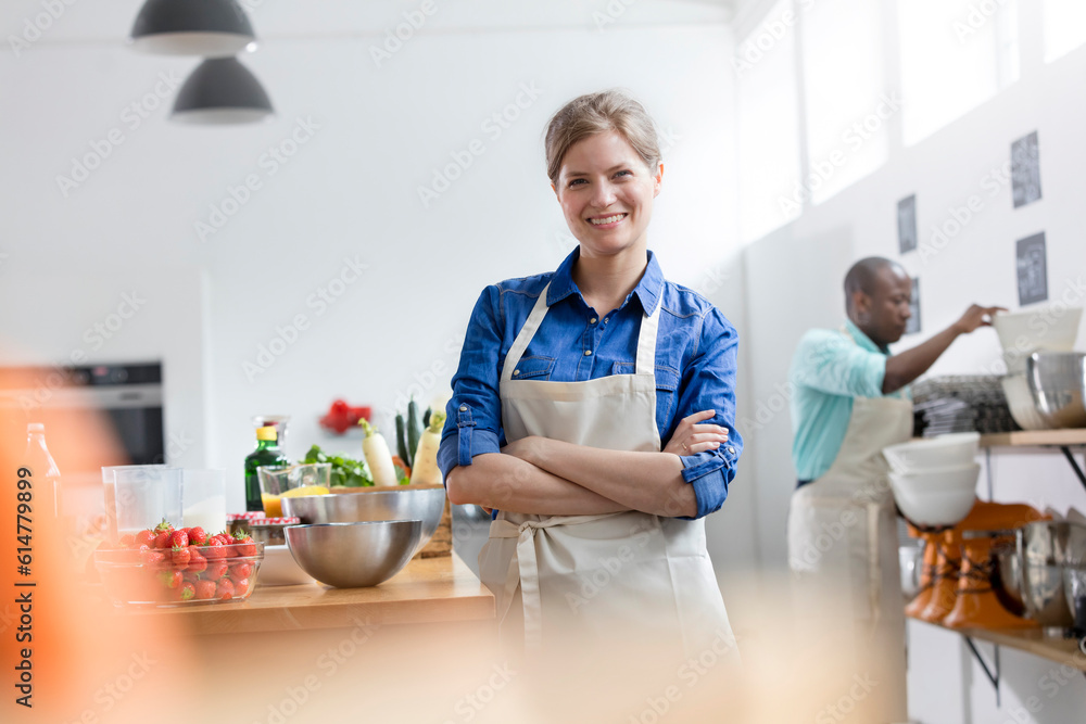 Portrait smiling female student in cooking class kitchen Portrait smiling female student in cooking class kitchen