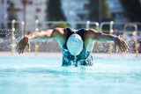 Male swimmer athlete butterfly stroke swimming swimming pool