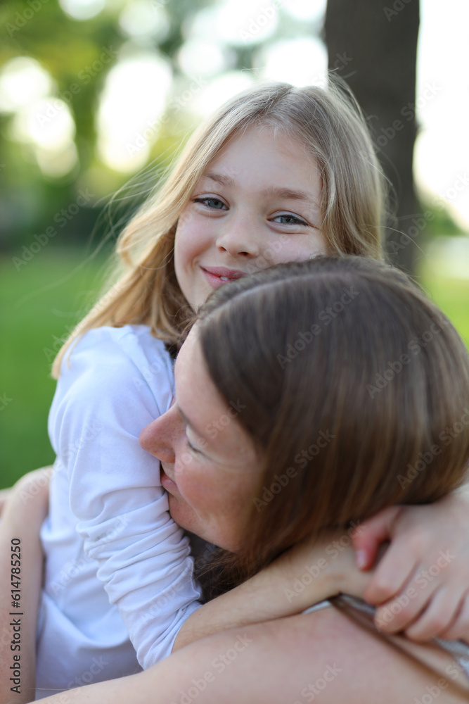 Cheerful mother and daughter hugging, portrait. Cheerful mother and daughter hugging, portrait.