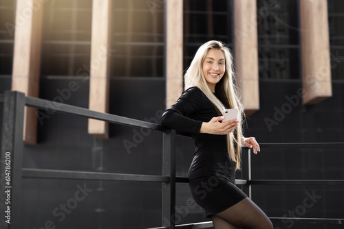 happy businesswoman with mobile phone outdoors  © Alexandr