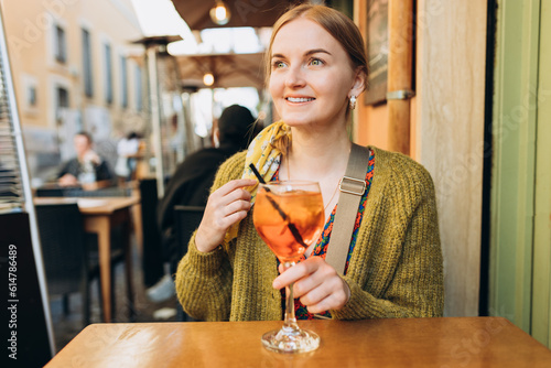 Photography Happy 30s girl sitting on the cafe terrace on the city street