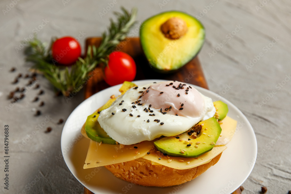 Plate with tasty egg Benedict on grey background, closeup Plate with tasty egg Benedict on grey background, closeup