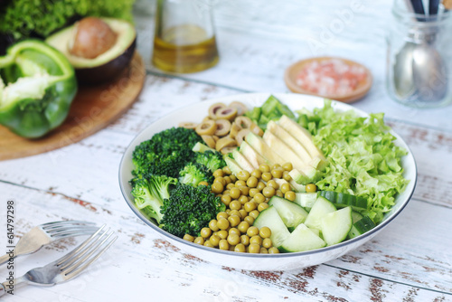 A bowl with a salad made of green vegetables